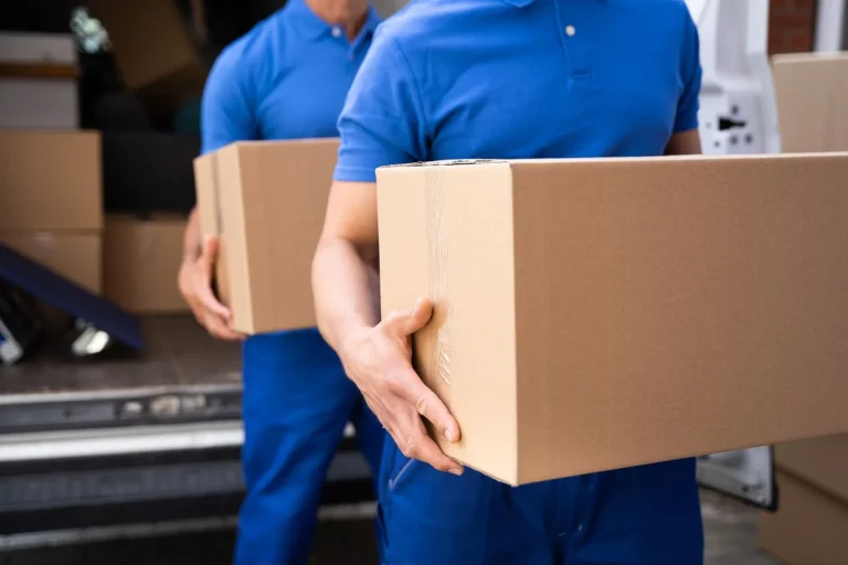 Movers carry boxes during the busy moving season